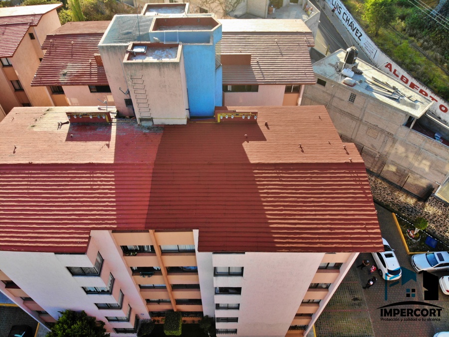 Impermeabilización en edificio con productos acrílicos base agua color terracota
